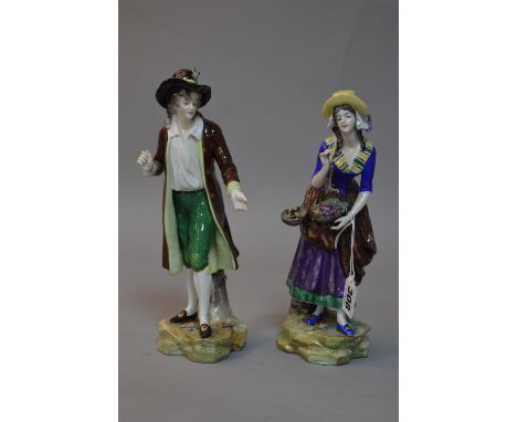 A PAIR OF VOLKSTEDT FIGURES, lady with scales and grapes and gentleman holding arm out (finger and thumb broken) (2)