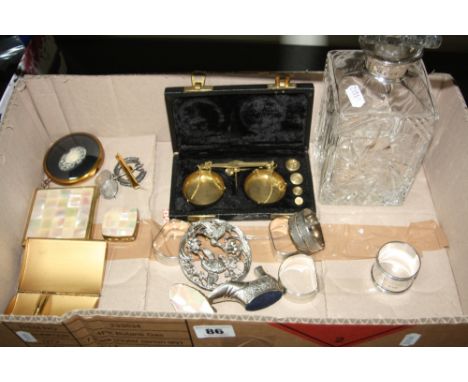 A SILVER RIMMED DECANTER, compacts, napkin rings, scales, etc