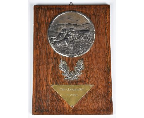 A German Army (Heer) Machine Gunners Plaque mounted on oak , above silvered oak leaves, below a brass triangle inscribed 'Gew