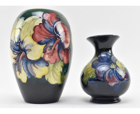 Moorcroft Pottery - Two 20th century tube lined glazed ceramic vases in the Hibiscus and Anemone patterns. The lot to include