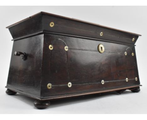 An early 19th century rosewood and ebony strung inlaid tea caddy with mother of pearl detailing. The caddy of sarcophagus for