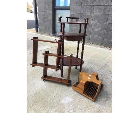 A set of hanging shelves, a hall table and a small carousel leaflet holder.