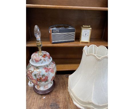 A portable 'Roberts' radio, a ceramic lamp and a modern carriage clock.