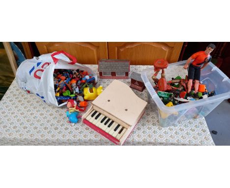 A vintage toy piano, model railway buildings and other toys.