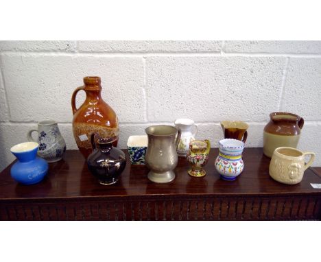 Decorated silver-plated tankard, with a collection of decorated ceramic jugs and other ceramics.