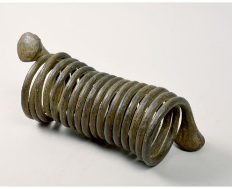 A 19c coiled iron slave bangle, 11in l.