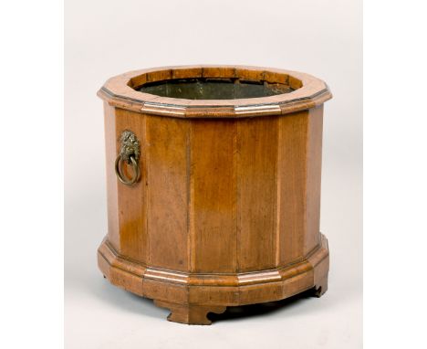 An early 19c walnut Dutch jardiniere banded and with lion mask ring handles, on four bracket feet, 11in diam, 10in h.