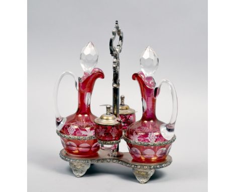 A late 19c/early 20c cruet stand comprising two ruby fluting incised claret jugs together with two pots and covers, both with