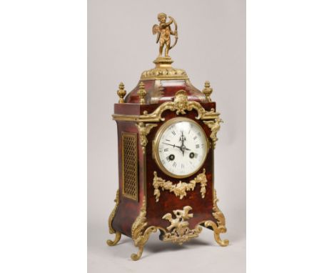 A late 19c French mantel clock in tortoiseshell case with cast gilt mounts and feet.  The case sides have gilt sound grilles 