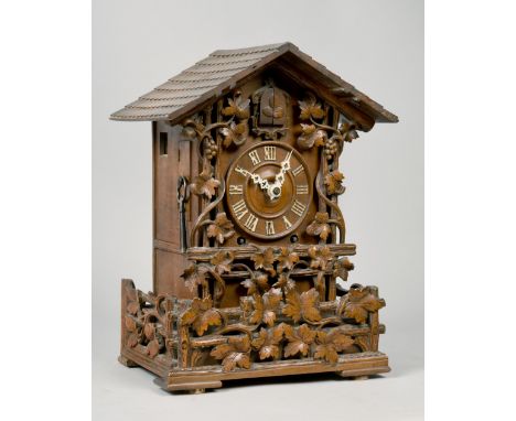 A late 19c Black Forest chalet style cuckoo mantel clock retailed by Camerer Kuss &amp; Co.  The wooden framed double fusee m