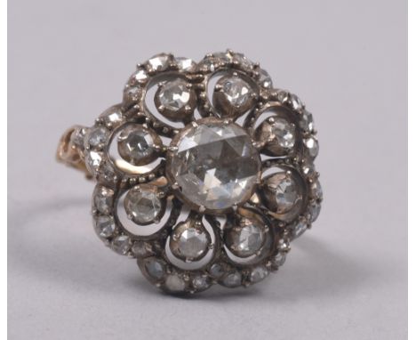 A gold diamond cushion set ring, the central stone .75ct.