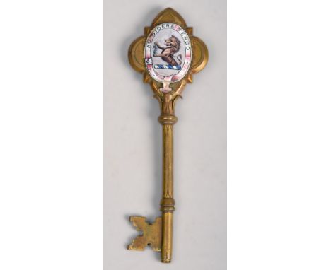 A late Victorian brass souvenier opening key, cats and engraved and bearing a plaque 'Presented to J.W Sidebotham Esq. MP, on