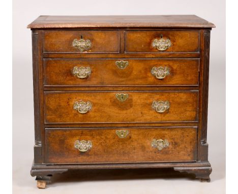 A mid Georgian walnut chest of two short and three long graduated drawers with fluted column corners, on bracket feet, 36in w