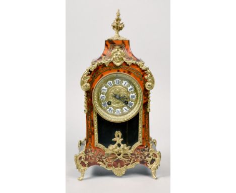 A late 19c French mantel clock in case with boullework front and having gilt mounts and feet.  The 4in diam dial is of emboss