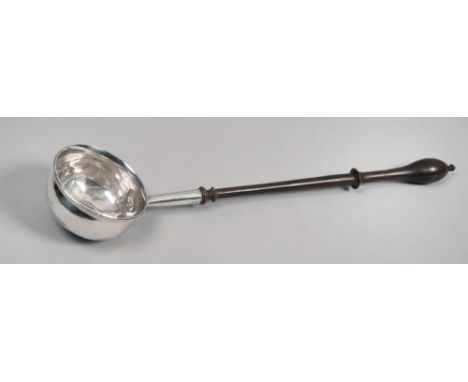 A late Georgian silver toddy ladle with coin insert, having a turned wood handle, 10.25in l.