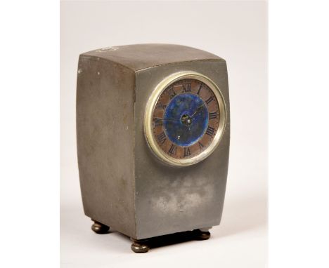 A late 19c mantel clock retailed by Liberty &amp; Co in rectangular pewter case with shallow carved sides and bun feet.  The 