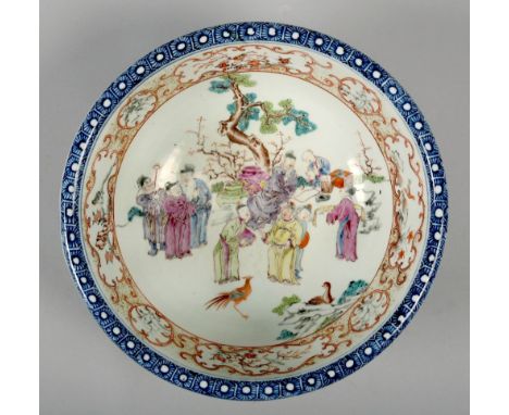 A late 18c/early 19c Chinese wash bowl, of circular form, inside decorated with many figures in a garden setting in famille r