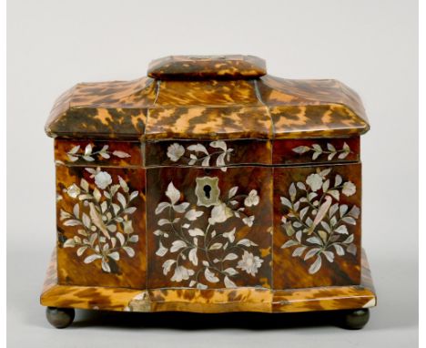 A late Georgian blond tortoiseshell two compartment tea caddy of serpentine form, the caddies with lift off covers (lining mi