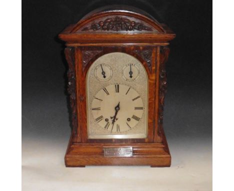 An early 20c German bracket clock by Winterhalder and Hoffmieir in oak case with round top and stepped base and having floral