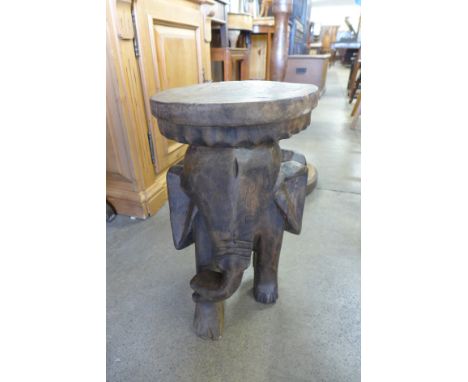 A hardwood carved elephant stool and a standard lamp