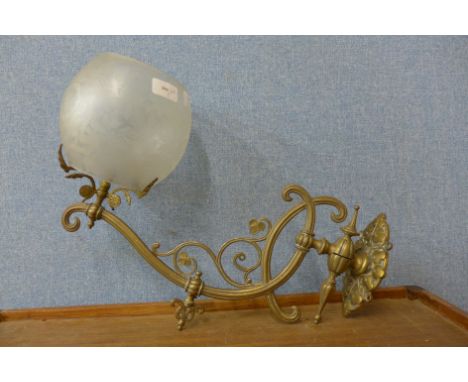 A Victorian Aesthetic Movement wall mounted gas light, with frosted glass shade