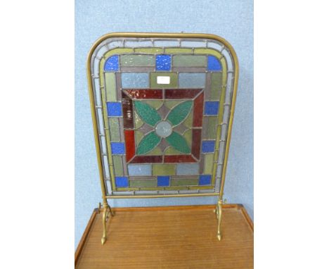A Victorian Aesthetic Movement stained glass and brass fire screen