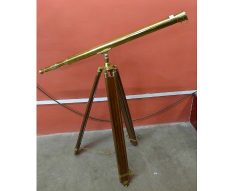 A brass telescope on tripod stand