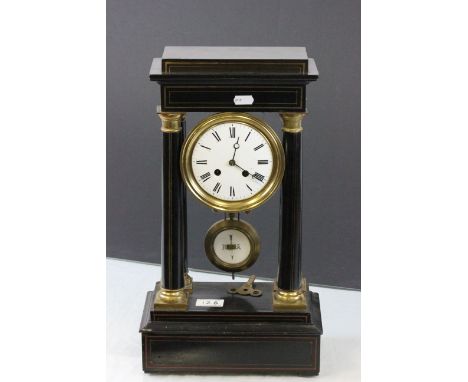 French gilt & black Wooden clock with enamel dial & key & supported on four columns, marked to movement L M Paris