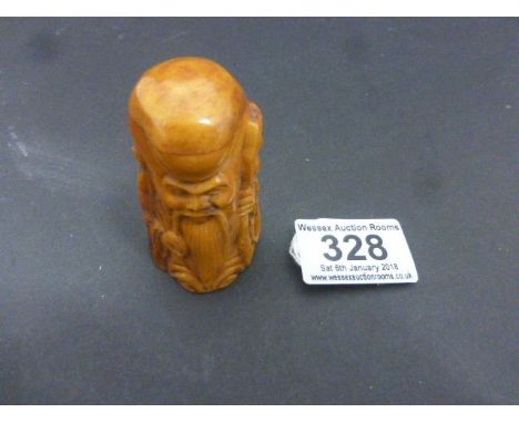 Bone netsuke of an old man with stake