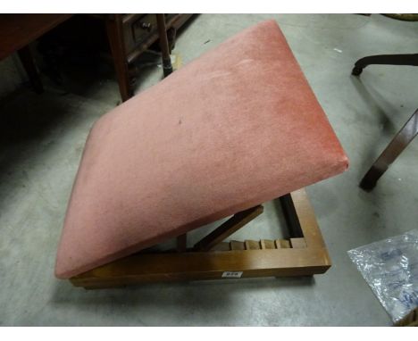 A vintage pink upholstered adjustable gout stool.