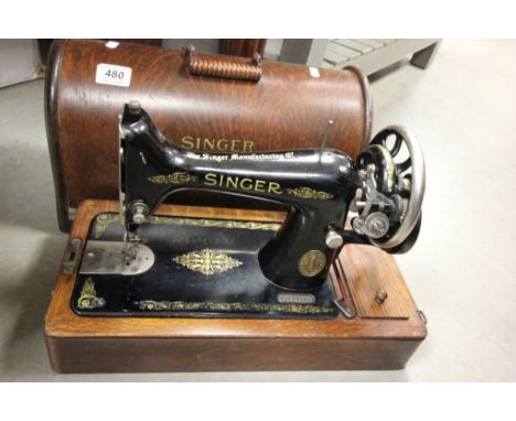 An oak  cased vintage Singer sewing machine.