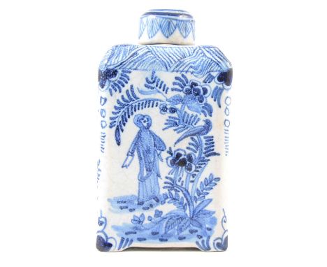 English Delft tea caddy, cylindrical lid, rectangular form with sloped shoulders, hand painted to both sides with a figure by