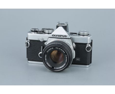 An Olympus OM-1n SLR Camerachrome, serial no. 1804201, with F.Zuiko Auto-S f/1.8 50mm lens, body, G, shutter working, lens, V