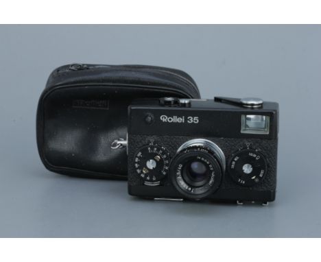 A Rollei 35 Compact Camera,black, with Rollei Tessar f/3.5 40mm lens, body, F-G, shutter working, lens, F-G, some light inter