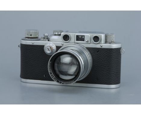 A Leica IIIb Rangefinder Camera,chrome, serial no. 335180, with Leitz Summitar f/2 50mm lens, chrome, serial no. 522337, body