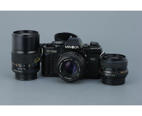 A Minolta X-700 SLR Camera Set-Upblack, with a MD Rokkor f/1.7 50mm lens, a MD Rokkor f/3.5 28mm lens, and an f/3.5 135mm len