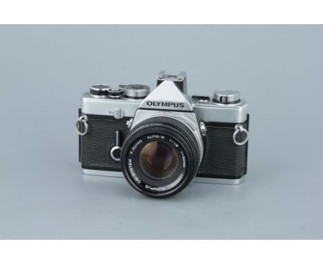 An Olympus OM-1 SLR Camerachrome, serial no. 1054812, with F.Zuiko Auto-S f/1.8 50mm lens, body, F-G, shutter working, lens, 