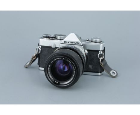 An Olympus OM-1n SLR Camerachrome, serial no. 2013222, with S Zuiko Auto-Zoom f/4 35-70mm lens, body, G, shutter working, len