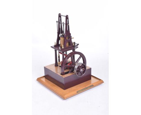 A Scratch built stationery live steam engineWith single piston, painted maroon on wooden base, with plank effect flooring, wi