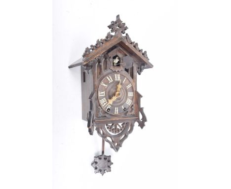 Wood framed cuckoo clock, late 19th Century, by Cammerer & Cuss13cm dial with Roman numerals, upper door to reveal cuckoo wit