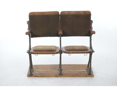 A pair of early 20th Century stained Beechwood and upholstered folding cinema chairsBoth chairs with concave padded backs abo