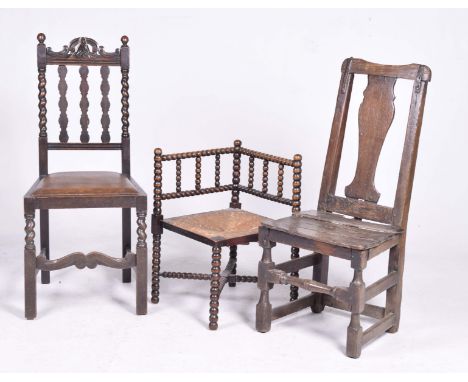 Three various oak chairsTo include a late 19th/early 20th Century bobbin turned corner chair with an envelope rush seat raise