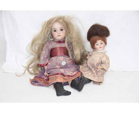 Two bisque headed dolls Comprising a doll with dark brown wig open/shut brown eyes open mouth impressed mark S&HK*&R, composi