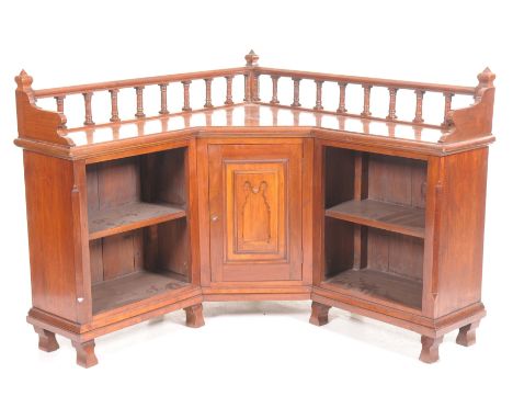 An unusual late Victorian ecclesiastical freestanding walnut corner bookcaseThe top with a turned spindled gallery above a ce