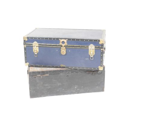 A vintage blue cabin trunk and a tin trunkThe cabin trunk with leather side handles, the tin trunk with iron drop handles, wi