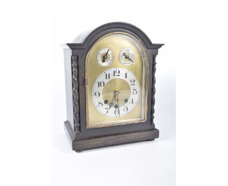 An oak cased mantle clock, early 20th CenturyThe 14cm silvered dial with Roman numerals, with slow, fast and silent dials, in
