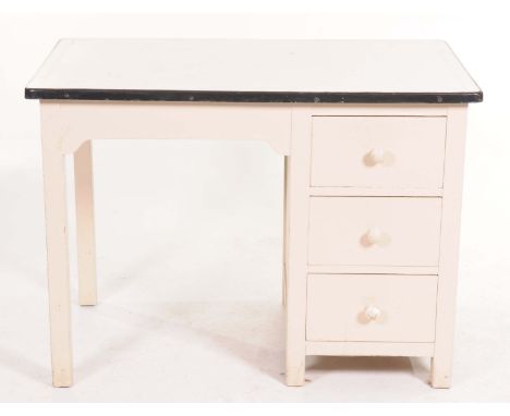 A painted pine enamel top kitchen/work tableThe rectangular painted enamel top above three drawers with turned knob handles o