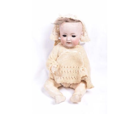 A German bisque headed dollWith auburn/brown wig, open/shut blue eyes, open mouth with tongue, impressed mark K*&R Simon & Ha
