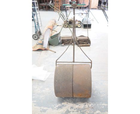 A Victorian cast iron garden rollerThe T-bar with a cast shell terminal, the roller with two drum cylinders, drum width 50cm.