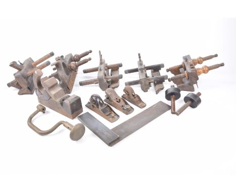 A collection of woodworking tools To include an ebonised and brass mounted square, wooden block plane, moulding planes etc.